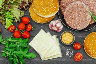 Burger patties. Beef cutlets, buns, vegetables and sauce. Homemade American classic