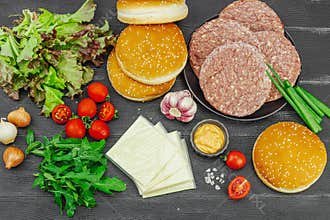 Burger patties. Beef cutlets, buns, vegetables and sauce. Homemade American classic