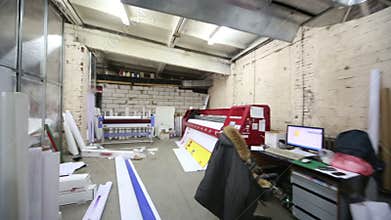 Room in printing house with large printer for