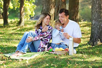 Young family having a picnic in nature