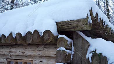 Close-up view of the authentic dugout log building in winter