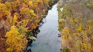 Autumn aerial above river with colorful riverbanks