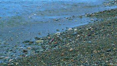 Sea Travel. Sea Foam Surf And Shiny Multi-Colored Pebbles. Background Of Sea Water.