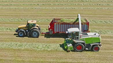 Harvest Dance: Tractors Bale Hay in Golden Fields with azure skies