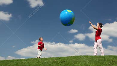 mother and son playing inflatable ball on