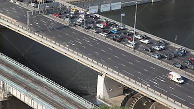 many cars moving on bridge above Moscow river, top