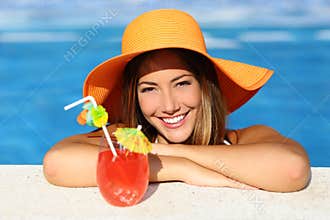 Beauty woman with perfect smile enjoying in a swimming pool on vacations