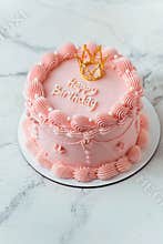 Delicate lambeth style birthday cake with pink cream frosting