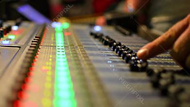 Audio Engineer Working Professional studio audio mixer with VU Meters