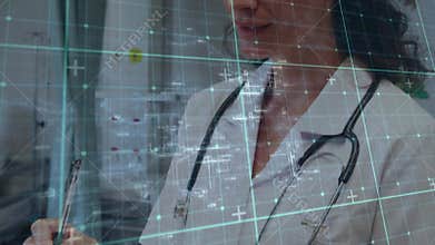 Female doctor writing on clipboard at station, grid scrolling aiding patient data recording