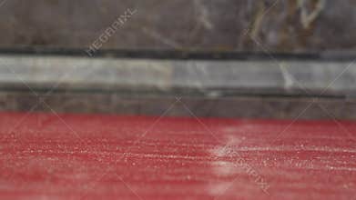 Dry carpet cleaning process using special cleaning brush and powder, spread on red carpet then brushed to absorb dirt before being