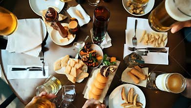 Friends gather to celebrate with drinks and food at a lively gathering in a cozy restaurant