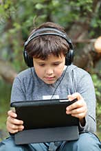 Teen boy in headphones with pad