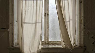 Dilapidated Window with Tattered Curtains and Peeling Paint in an Abandoned Room with Overcast Daylight