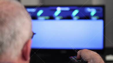 Smart tv and senior man pressing remote