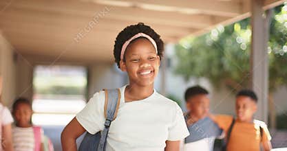 Diverse classmates following African girl leader walking covered corridor with backpacks to class