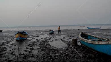 Fisherman dropping anchor near shore in coastal India