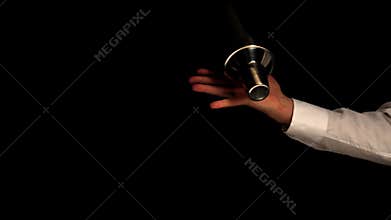 Barman shaking a cocktail on black background