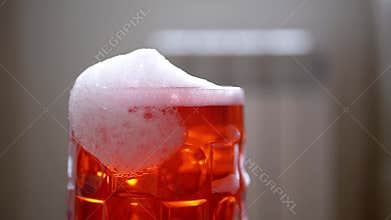 Red Sparkling Drink with Diminishing Foam
