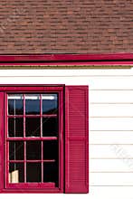 Red windon and gutters accent on the white house