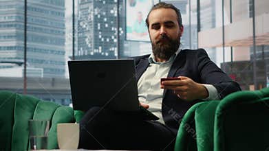 Responsible businessman verifies payment details on his laptop