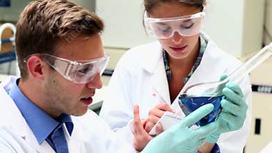 Focused science students examining chemical