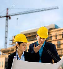 Architects reading blueprint