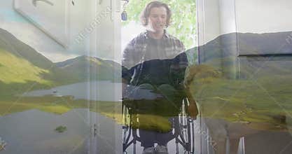 Sitting man in motorized wheelchair wearing plaid shirt over tee in entryway, with golden retriever