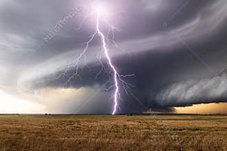 Supercell storm clouds with massive lightning strike