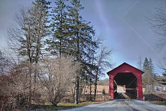 on the red river road you can pass through this red covered bridge