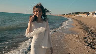 Young pretty girl walking near the seaside and