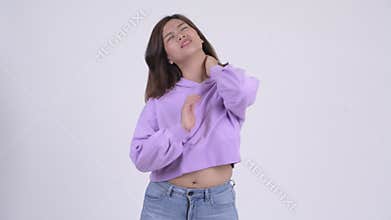 Young stressed Asian woman having neck pain