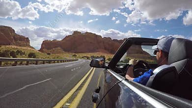 ARIZONA, USA - MAY 13, 2019: Man driving convertible car