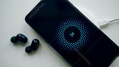 Mobile phone, earphones and a wireless charging block