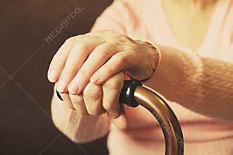 Close up of mature womans hands. Health care giving, nursing home. Parental love of grandmother. Old age related diseases.