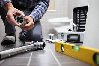 Hands plumber at work in a bathroom, plumbing repair service, as