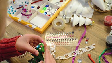 Children make crafts and toys, christmas tree and other. Painting watercolors. Top view. Artwork workplace with creative accessori