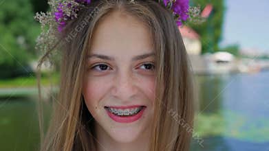 Portrait of happy female teen with braces on teeth smiling at camera. 4K