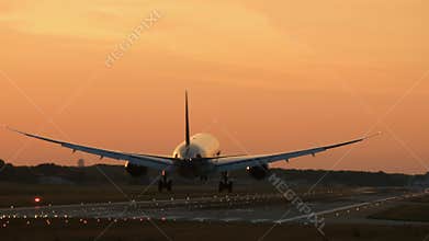 Widebody twin engine airplane landing in the early morning