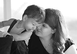Closeup loving mother and son whispering secrets into ears
