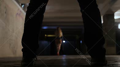 Female walking in underpass watched by criminal