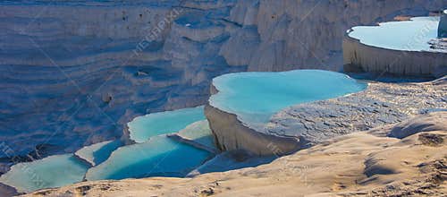 The natural white stone swimming pools fill with the thermal water