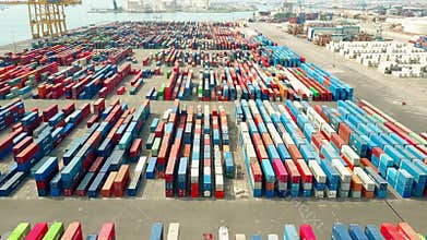 BARCELONA, SPAIN - APRIL, 15, 2017. Aerial shot of big port container yard and loader in action. 4K video