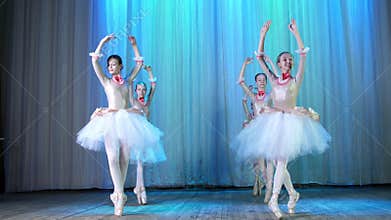 Ballet rehearsal, on the stage of the old theater hall. Young ballerinas in elegant dresses and pointe shoes, dance