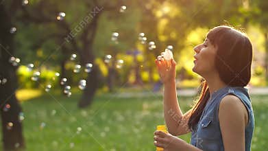 Woman blowing bubbles
