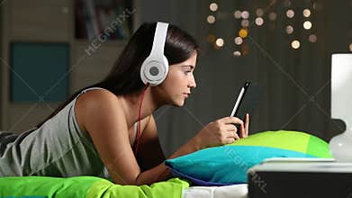 Teen e-learning with a tablet and headphones at home