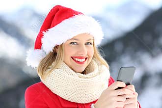 Lady on christmas holidays holding a smart phone