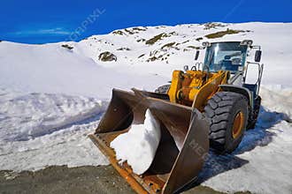Snow clearing excavator in Aran Valley