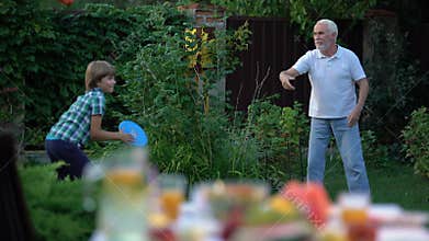 Kid playing throw and catch game with grandfather, active lifestyle, having fun