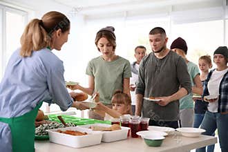 Volunteers serving food for poor people
